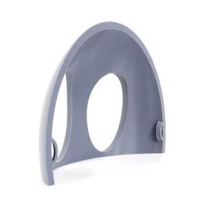 May include: A gray plastic half-dome with a circular opening and two small holes on the side.