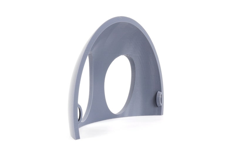 May include: A gray plastic half-dome with a circular opening and two small holes on the side.