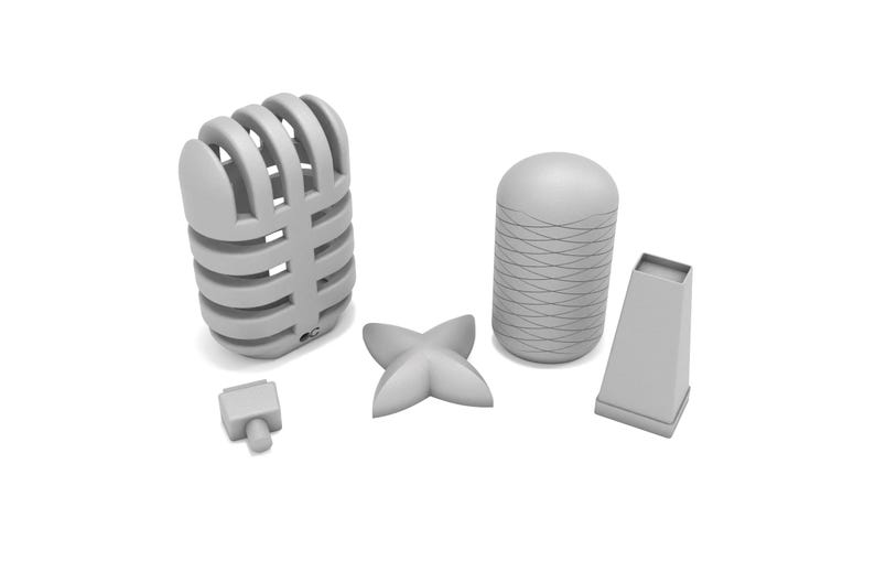 May include: Five gray 3D printed objects: a microphone, a cylinder with a textured surface, a four-pointed star, a small rectangular block, and a tall rectangular block.