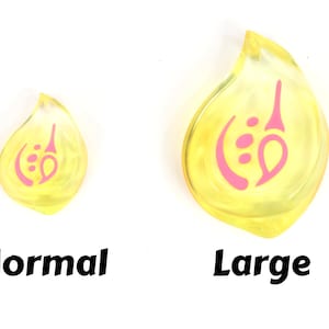 May include: Two yellow resin teardrop-shaped charms with a pink design. The charm on the left is smaller than the charm on the right. The text "Normal" is below the smaller charm and the text "Large" is below the larger charm.