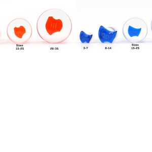 May include: Four sizes of clear glass ear gauges with a red or blue swirl design. The sizes are 3-7, 8-14, 15-25, and 26-35.