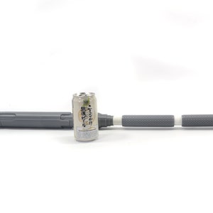 K&ouml;nnte beinhalten: Ein grauer Teleskopschlagstock mit einem wei&szlig;en Griff und einem schwarzen Etikett auf der Dose. Die Dose ist mit japanischem Text beschriftet.