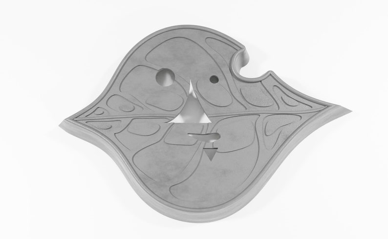 May include: A gray, leaf-shaped, decorative wall hanging with a carved design and two holes.