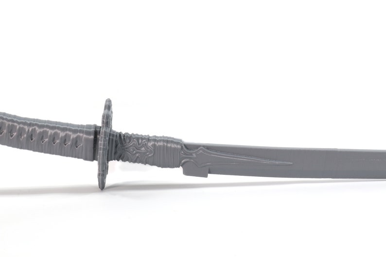 May include: A gray plastic katana sword with a detailed handle and a sharp blade.
