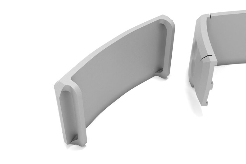 May include: Two light gray, curved architectural elements are displayed against a white background. Each element has a rectangular shape with a curved top and a recessed section on one end. The design is minimalist and modern.
