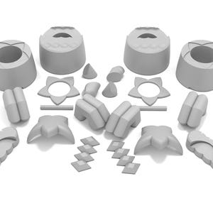 May include: A set of gray plastic toy building blocks with various shapes, including stars, circles, and rectangles.