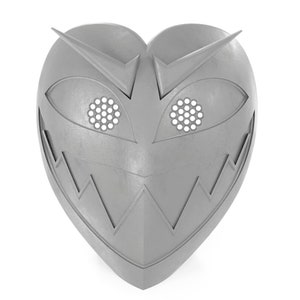 May include: A silver heart-shaped mask with a menacing grin, sharp points, and two eye holes with a honeycomb pattern.