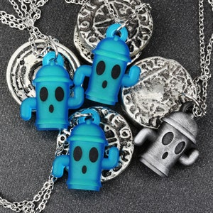 May include: Three silver necklaces with blue and silver fire hydrant charms. The fire hydrant charms have a surprised expression with two eyes and a mouth.