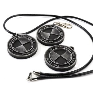 May include: Three silver-colored pendants with black straps. Each pendant features a circular design with the text "Gekkoukan Private High School Since 1982" and a stylized symbol.