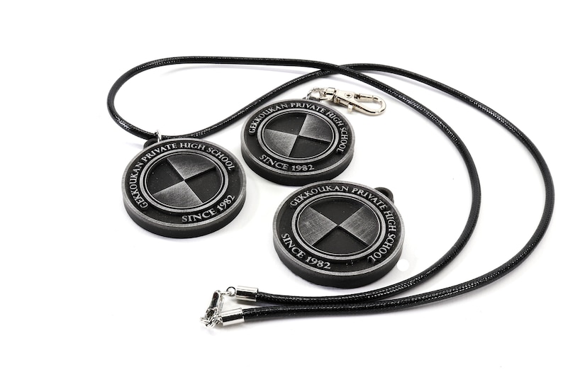 May include: Three silver-colored pendants with black straps. Each pendant features a circular design with the text "Gekkoukan Private High School Since 1982" and a stylized symbol.