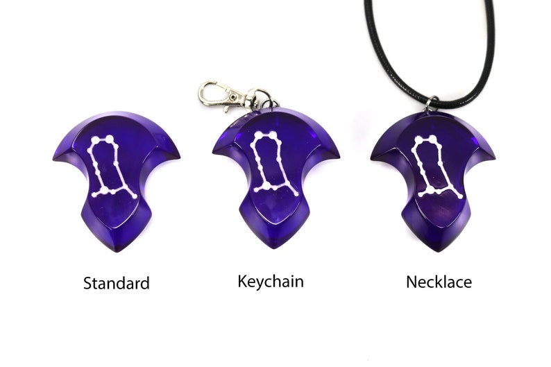 May include: Three versions of a purple pendant featuring the Gemini constellation in white. The pendant is available as a standard piece, a keychain, and a necklace.