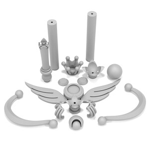 May include: A set of 3D printed pieces for a princess crown, featuring a crown, wings, and a wand. The pieces are all white and made of plastic.