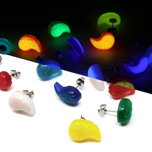 May include: A set of 10 glow-in-the-dark earrings in various colors, including red, orange, yellow, green, blue, and purple. The earrings are shaped like a kidney bean and have a silver post.