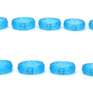 May include: Ten light blue silicone rings with a raised geometric design and a white logo. The rings are arranged in two rows of five.
