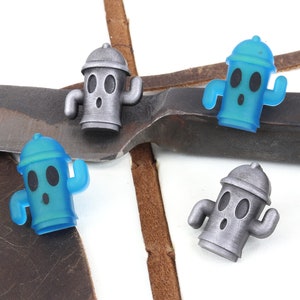 May include: Three small, cartoon-style fire hydrant figurines. One is silver, and two are blue.