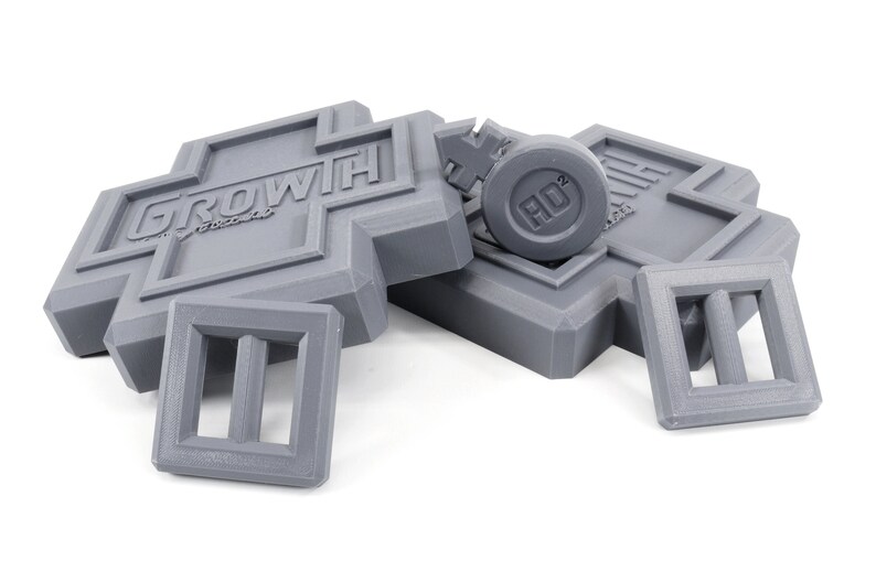 May include: Gray plastic building blocks with the word "GROWTH" printed on one block and a round gray block with the word "HD" printed on it.