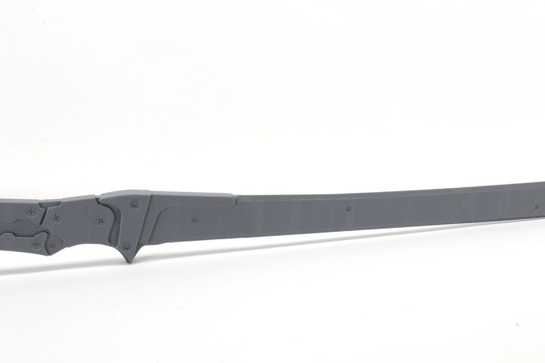 May include: A gray plastic sword with a detailed handle and a straight blade.