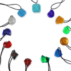 May include: A set of 12 colorful pendants with different symbols on each. The pendants are on black cords and are arranged in a circle on a white background.