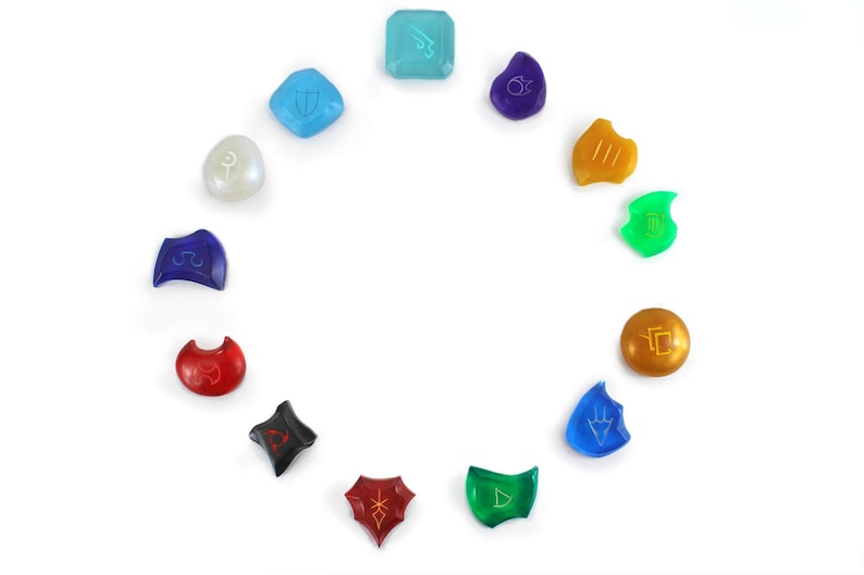 May include: A set of 12 colorful, translucent, gemstone-like dice with different symbols on each face. The dice are arranged in a circle on a white background.