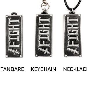 May include: A silver pendant with the word "FIGHT" in a pixelated font and a small sword graphic. The pendant is shown in three variations: standard, keychain, and necklace.