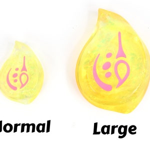 May include: Two yellow teardrop-shaped resin charms with a pink swirl design. The charm on the left is labeled "Normal" and the charm on the right is labeled "Large".