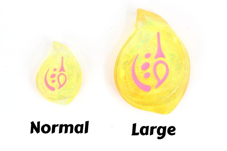 May include: Two yellow teardrop-shaped resin charms with a pink swirl design. The charm on the left is labeled "Normal" and the charm on the right is labeled "Large".