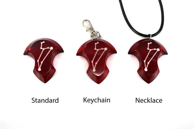 May include: Three red resin pendants with a white constellation design. The pendants are shown in three different styles: standard, keychain, and necklace.