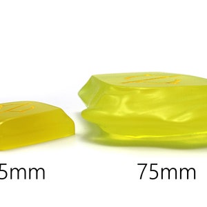 May include: Two translucent yellow resin blocks with the letter "Z" etched on top. The smaller block is 45mm, and the larger block is 75mm. The blocks are on a white background.