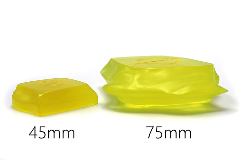 May include: Two translucent yellow resin blocks with the letter "Z" etched on top. The smaller block is 45mm, and the larger block is 75mm. The blocks are on a white background.