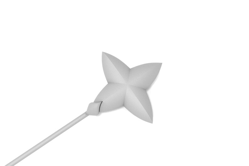 May include: A white, four-pointed star-shaped object attached to a long, thin, white stick. The object is made of a soft, pliable material.