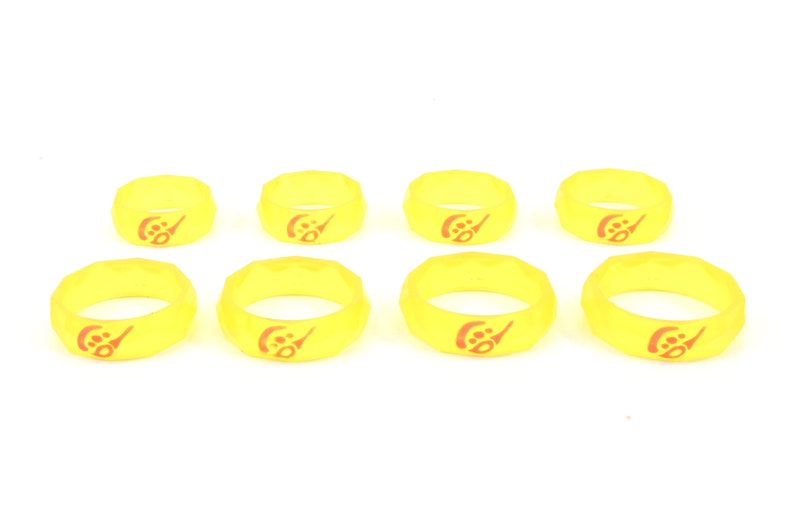 May include: Eight yellow silicone rings with a red logo. The logo is a stylized letter "C" with a small circle inside.