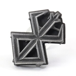 May include: A silver-colored metal ring with a geometric design. The ring is made of multiple layers of metal, creating a three-dimensional effect.