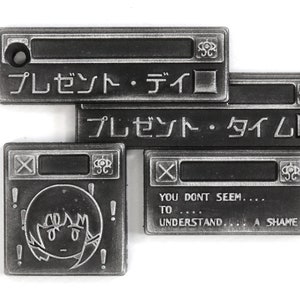 May include: Four silver metal pins with a computer window design. The top two pins have Japanese text that reads "プレゼント・ディロ" and "プレゼント・タイム". The bottom left pin has a cartoon drawing of a person with exclamation points around the head. The bottom right pin has the text "YOU DONT SEEM.... TO .... UNDERSTAND... A SHAME".