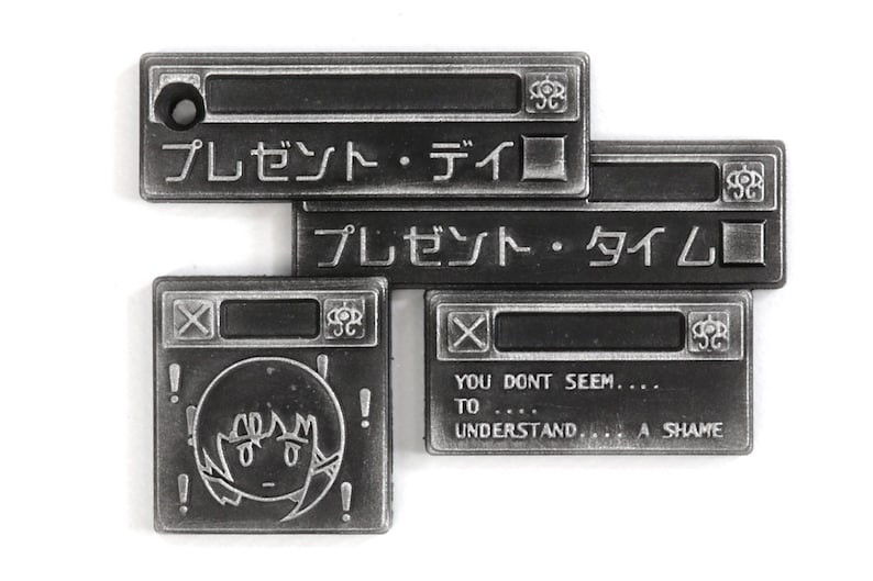 May include: Four silver metal pins with a computer window design. The top two pins have Japanese text that reads "プレゼント・ディロ" and "プレゼント・タイム". The bottom left pin has a cartoon drawing of a person with exclamation points around the head. The bottom right pin has the text "YOU DONT SEEM.... TO .... UNDERSTAND... A SHAME".