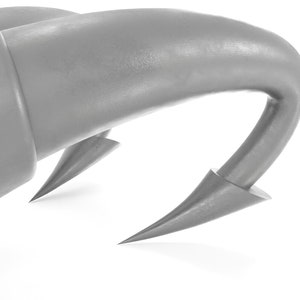 May include: Close-up of a silver metal hook with a sharp point. The hook is curved and has a smooth, shiny surface.
