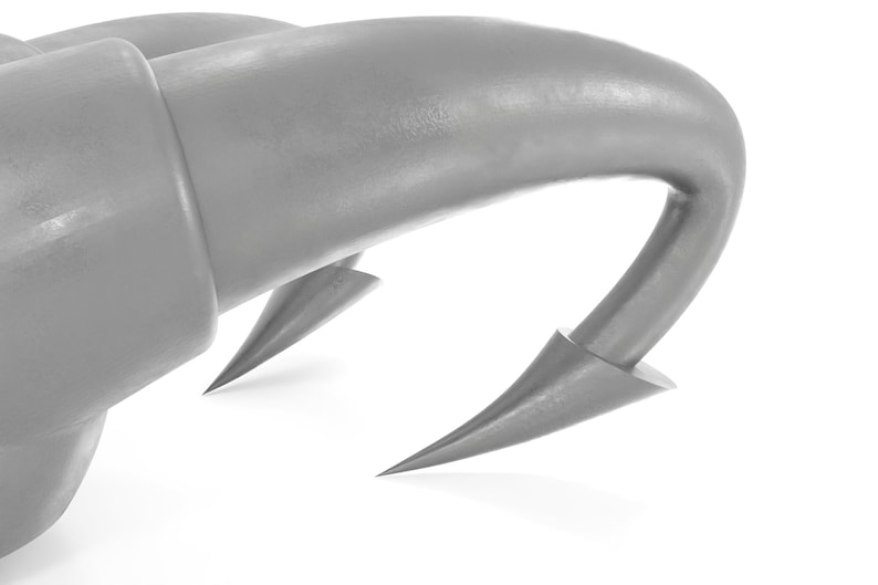 May include: Close-up of a silver metal hook with a sharp point. The hook is curved and has a smooth, shiny surface.