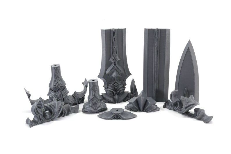 May include: A set of 10 gray plastic pieces that can be assembled into a sword. The pieces are detailed with intricate designs.