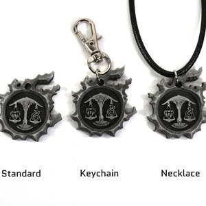 May include: Three silver-colored pendants with a black and white design of a scale with a heart and a snake on each side. The pendants are shown in three different styles: standard, keychain, and necklace.