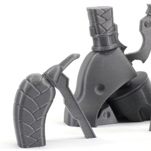May include: A set of three gray 3D printed parts for a model gun. The parts include a handle, a trigger, and a barrel.