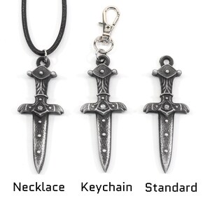 May include: Three silver dagger pendants in different styles: necklace, keychain, and standard. Each pendant features a detailed design with a pointed tip and a cross-shaped handle.