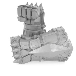 May include: A silver robotic hand with a spiked fist and a mechanical forearm. The hand is closed into a fist with sharp metal spikes on the knuckles.