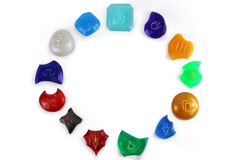 May include: A set of 12 colorful glass game pieces with different symbols. Each piece is a different shape and color, and they are arranged in a circle on a white background.