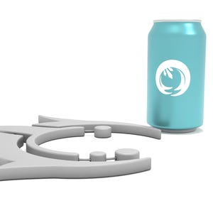May include: A light blue aluminum can with a white logo and a gray, abstract arrow-shaped object. The can is cylindrical and stands upright. The arrow-shaped object is made of gray plastic.