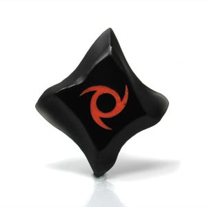 May include: Black diamond-shaped ninja star with a red swirling symbol in the center.