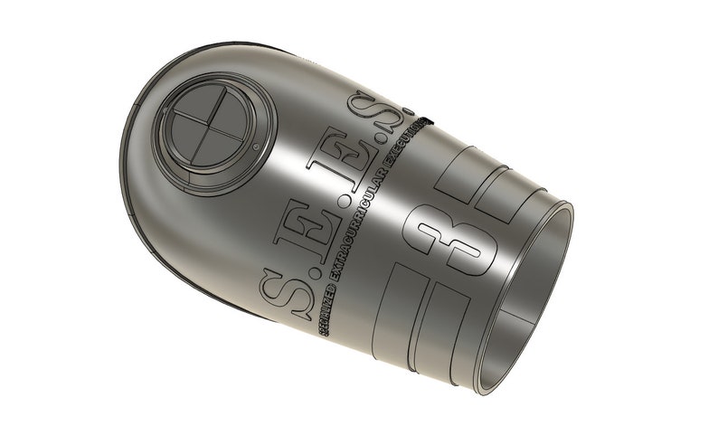 May include: A metallic gray, cylindrical object with the text "S.E.S. STAINED EXTRACURRICULAR EXECUTIONS" and the number "3" etched on its surface. The object has a rounded top with a circular design.