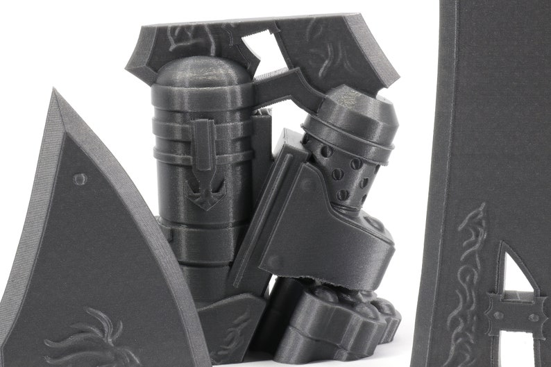 May include: A 3D printed model of a knight in armor, with a helmet and a sword. The knight is standing on a base with a decorative design.