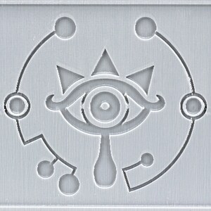 May include: A gray and white stylized eye with a teardrop shape below it. The eye is surrounded by a circle with five smaller circles around it.