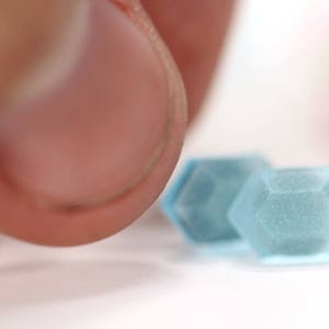 K&ouml;nnte beinhalten: Zwei facettierte Glasperlen in hellblau.
