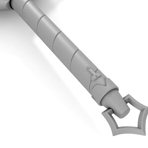 May include: A close-up of the end of a silver sword handle. The handle is decorated with a series of raised rings and a decorative design at the end.