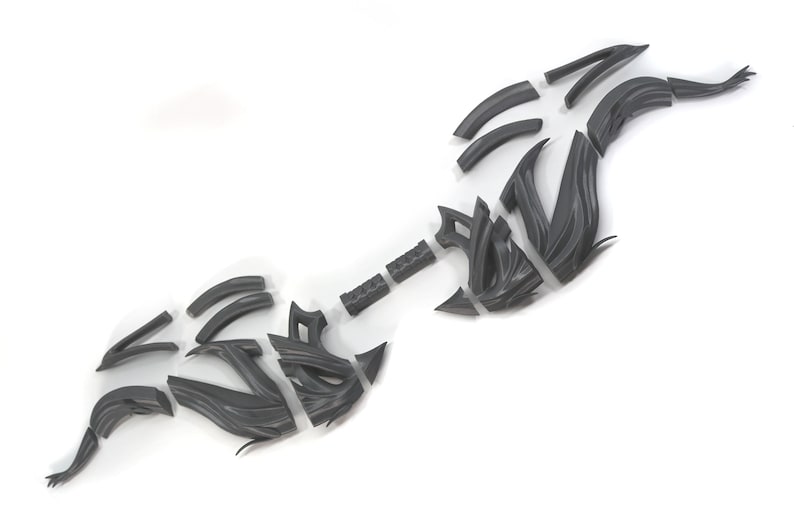 May include: A 3D printed model of a bow and arrow, disassembled into multiple pieces. The bow is made of a dark gray plastic and has a complex, intricate design. The arrow is also made of dark gray plastic and has a simple, straight design.